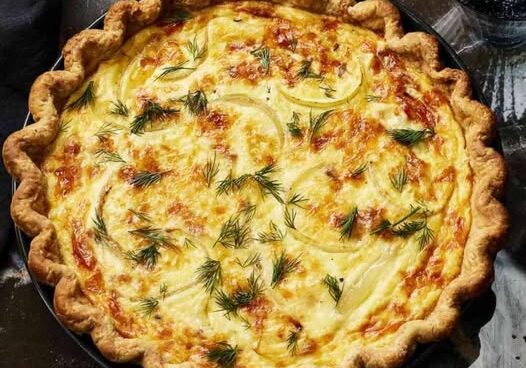 Savory quiche with dill garnish.