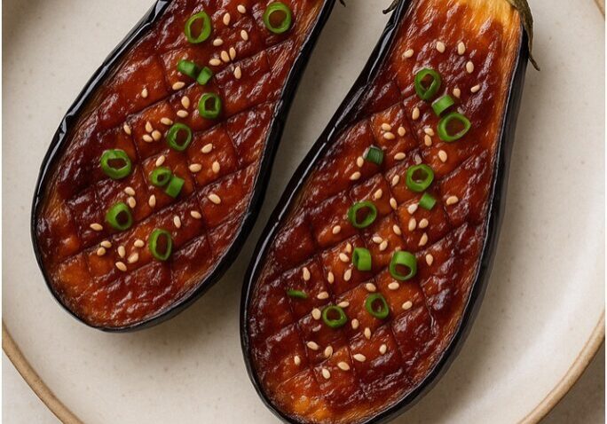 Grilled eggplants garnished with green onions.