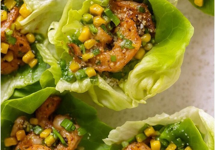 Shrimp lettuce wraps with corn and herbs.