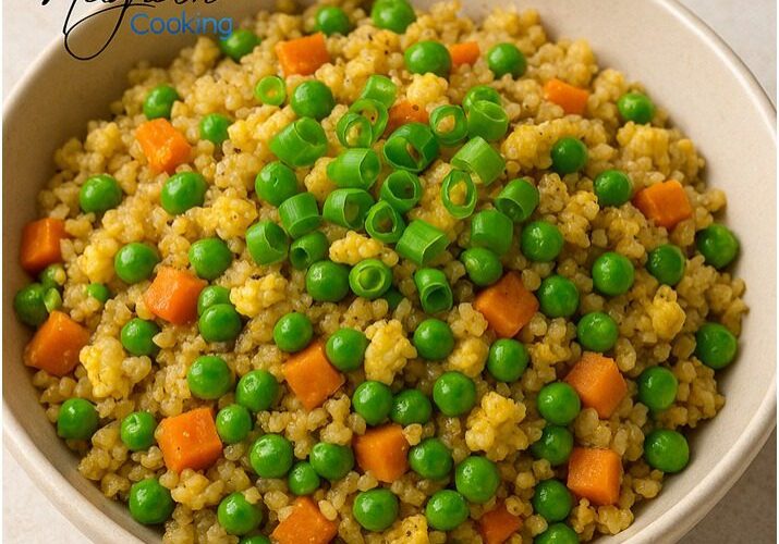Bowl of couscous with peas and carrots.