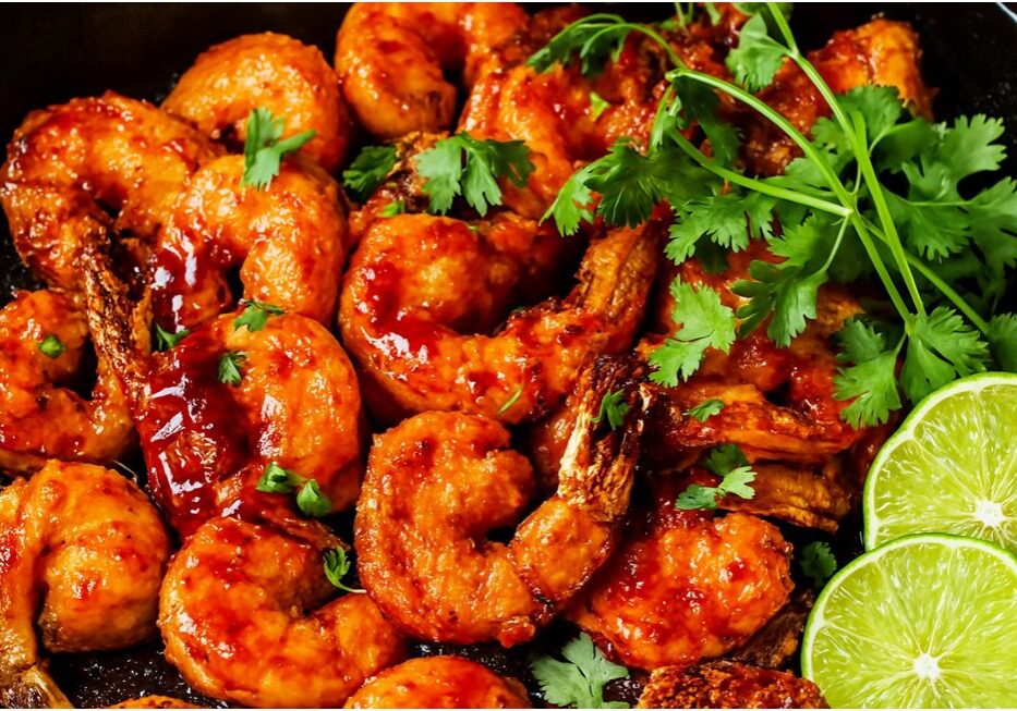 Spicy shrimp with cilantro and lime slices.
